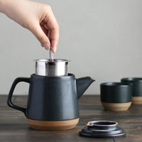 black ceramic teapot being used